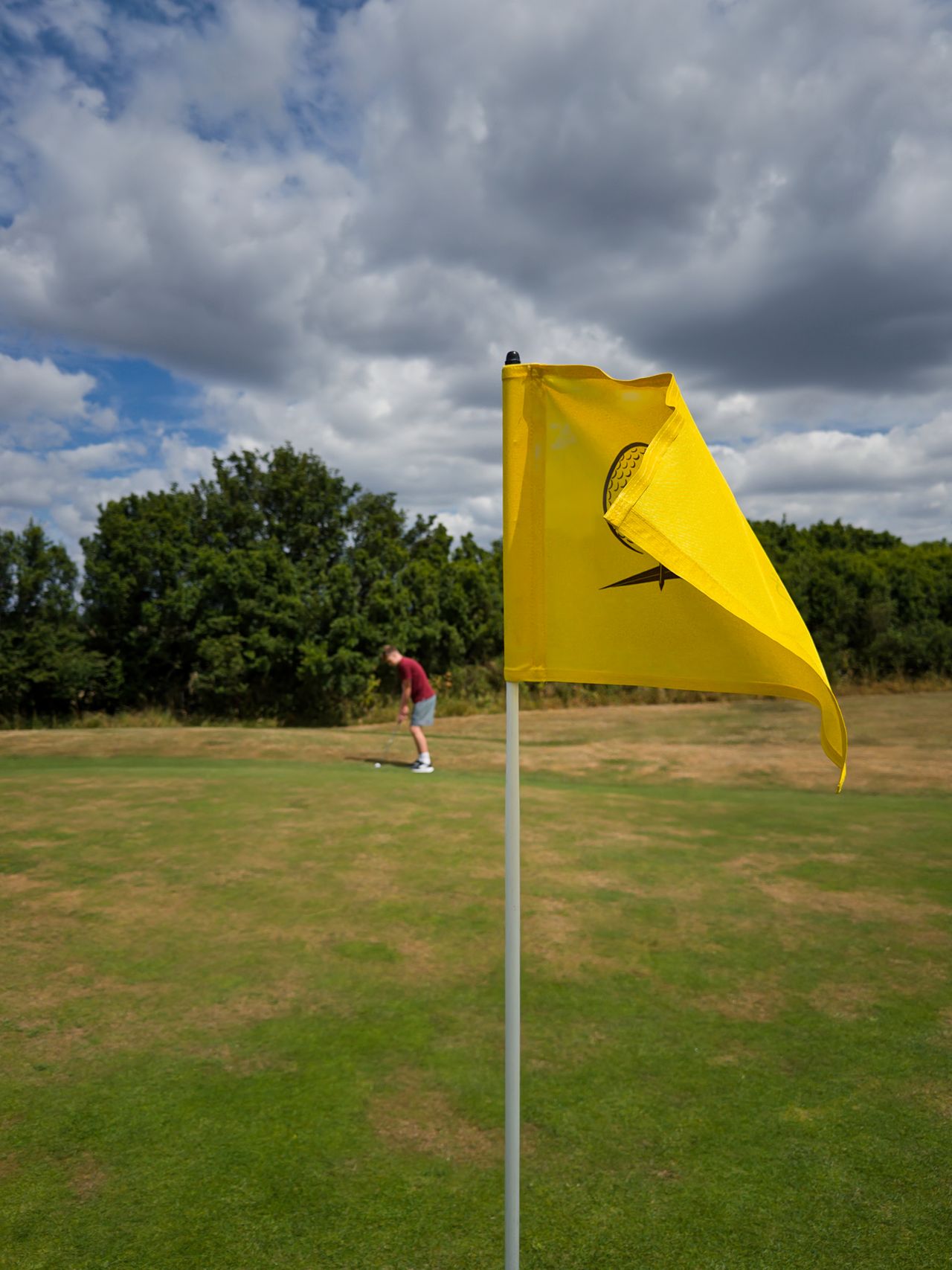 Active middle-aged man walking a golf course in the early morning